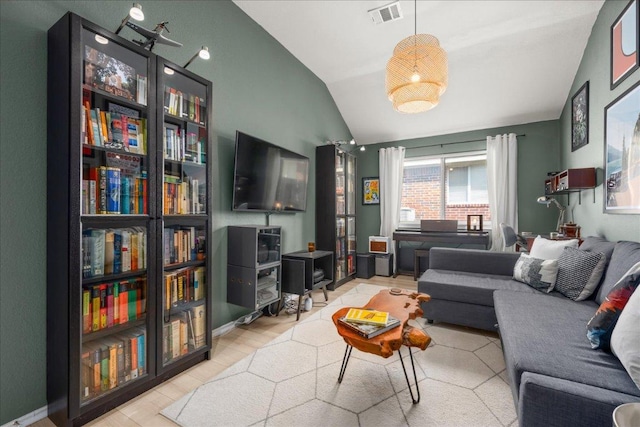 living room featuring visible vents and vaulted ceiling