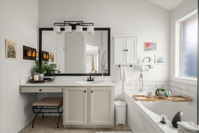 full bath featuring a bath, vanity, and tile patterned flooring