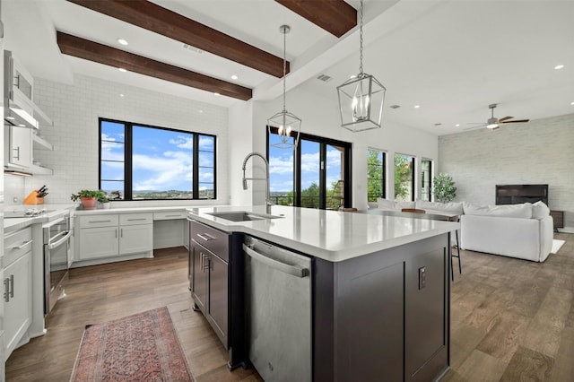 223 Honey Creek Ct Unit 12, Lakeway, TX 78738 - kitchen with stainless steel appliances, open shelves, light countertops, beam ceiling, and dark wood finished floors