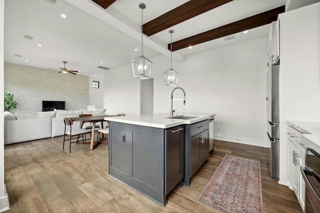 223 Honey Creek Ct Unit 12, Lakeway, TX 78738 - kitchen with a ceiling fan, light countertops, an island with sink, light wood-style floors, and recessed lighting