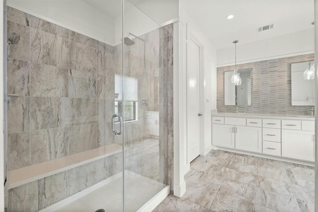 bathroom featuring double vanity, visible vents, a stall shower, and recessed lighting