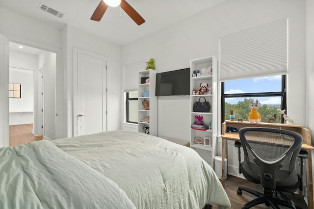 223 Honey Creek Ct Unit 12, Lakeway, TX 78738 - bedroom with wood finished floors and a ceiling fan