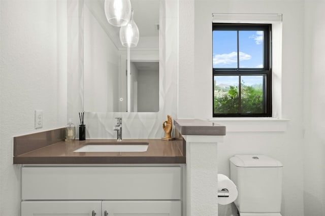 bathroom featuring toilet and vanity