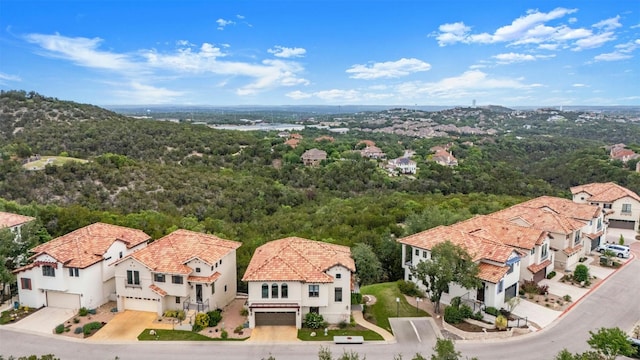 birds eye view of property featuring a view of trees and a residential view