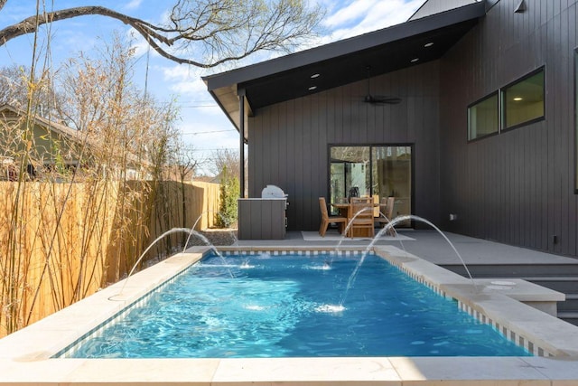 view of pool with a ceiling fan, a patio area, fence, and a fenced in pool