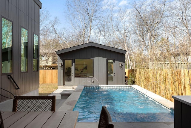 view of pool featuring an exterior structure, a fenced backyard, a fenced in pool, and an outdoor structure