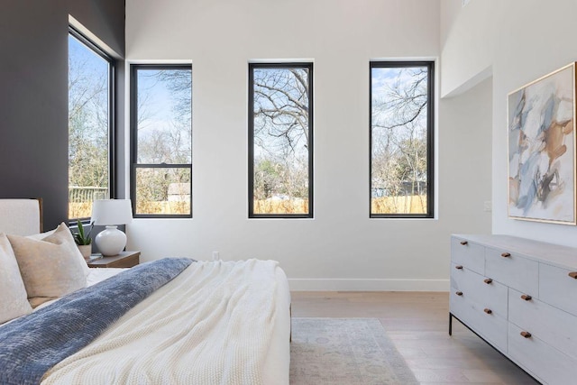 bedroom featuring wood finished floors and baseboards