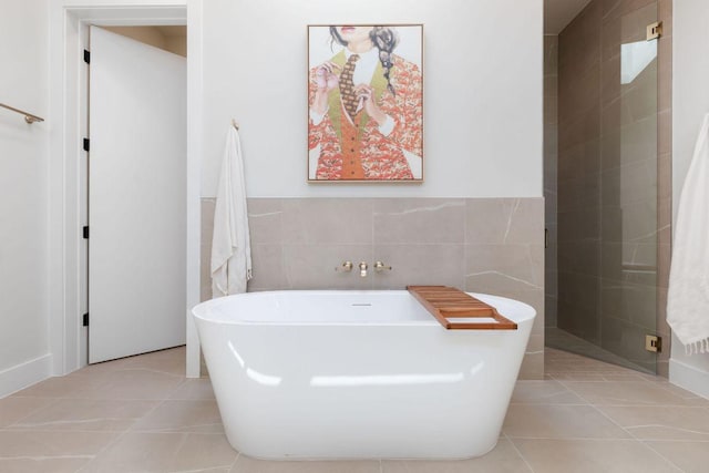 5514 Montview St, Austin, TX 78756 - full bathroom featuring tile walls, tile patterned floors, a freestanding bath, and a wainscoted wall