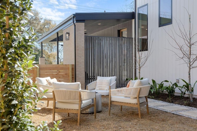 view of patio featuring outdoor lounge area and fence