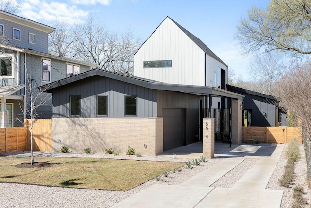 view of front facade featuring a gate, fence, and brick siding