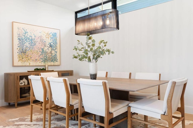 dining area with wood finished floors