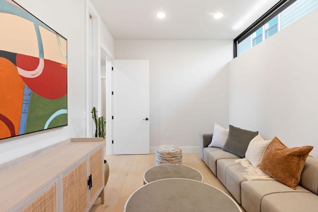 living area with recessed lighting, baseboards, and light wood-style floors