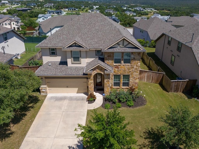 view of front of house featuring a shingled roof, stucco siding, a garage, stone siding, and driveway