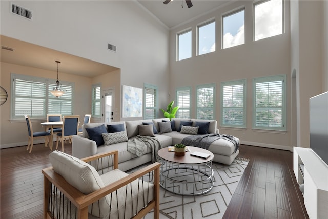 living room with baseboards, dark wood-style floors, visible vents, and ceiling fan