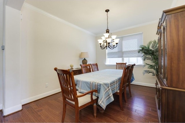 dining room with dark wood-style floors, baseboards, a chandelier, and crown molding