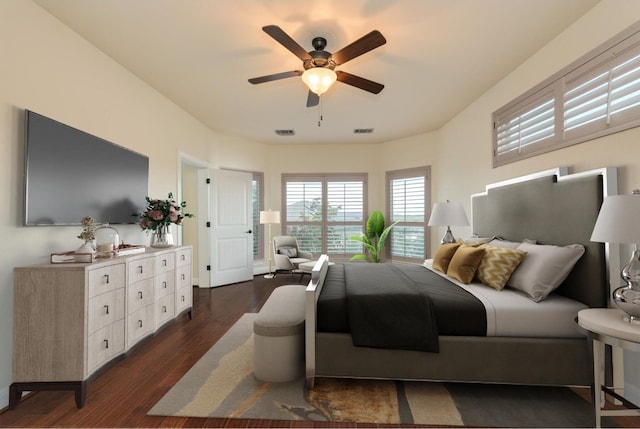 bedroom with visible vents, dark wood-type flooring, and ceiling fan