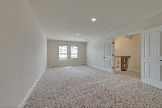 unfurnished room with recessed lighting, baseboards, and carpet floors