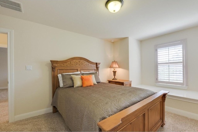 bedroom with visible vents, baseboards, and light colored carpet