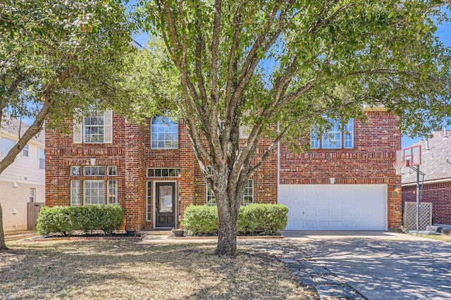 view of front of house featuring brick siding, driveway, and a garage