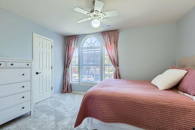 bedroom featuring visible vents, carpet floors, baseboards, and ceiling fan