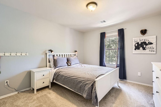 bedroom with visible vents, light colored carpet, and baseboards