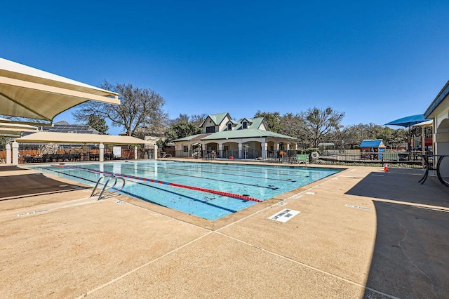 community pool featuring a gazebo, a patio area, and fence