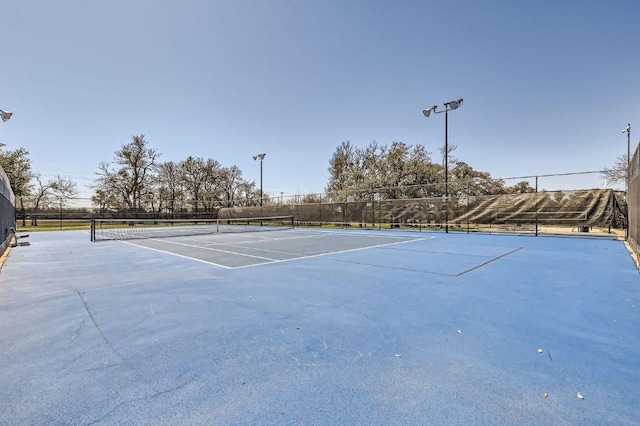 view of sport court featuring fence