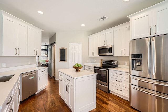 kitchen with visible vents, appliances with stainless steel finishes, dark wood finished floors, and white cabinets