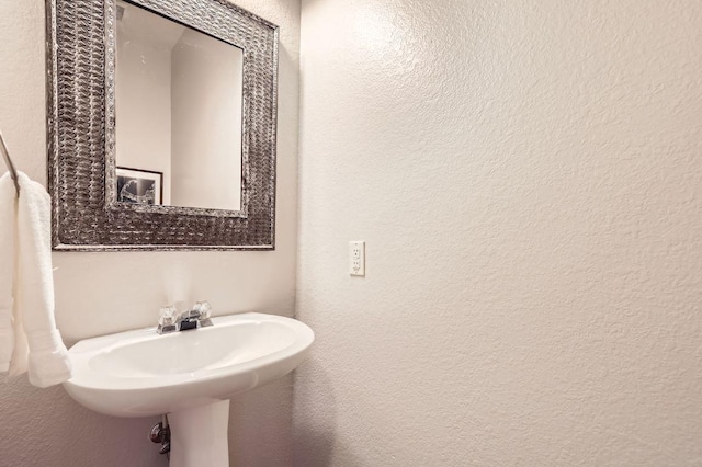 bathroom featuring a textured wall