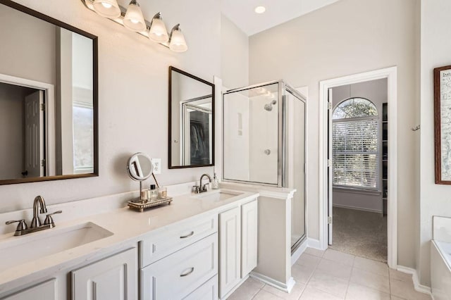 full bathroom with tile patterned flooring, a shower stall, and a sink