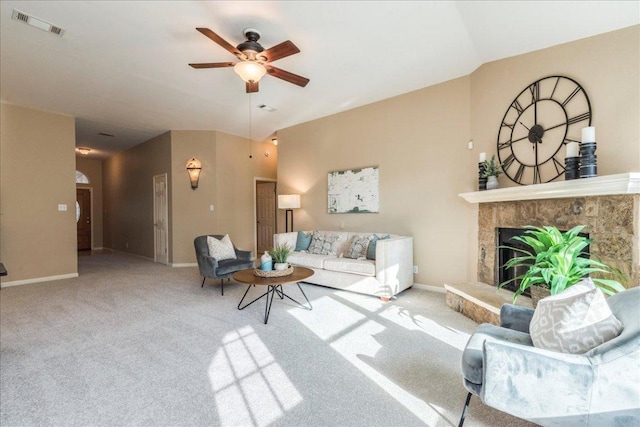 carpeted living room with visible vents, baseboards, lofted ceiling, and a ceiling fan