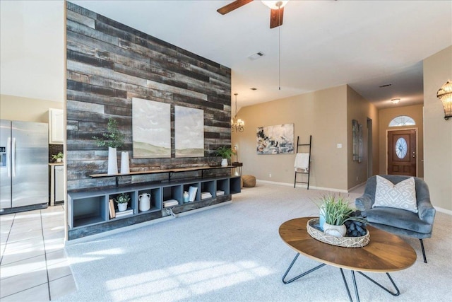 living room with light carpet, baseboards, visible vents, and ceiling fan