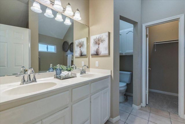 full bathroom featuring tile patterned floors, toilet, double vanity, and a sink