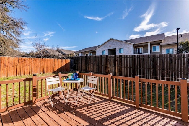 wooden deck featuring a fenced backyard