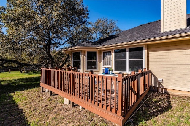 wooden deck featuring a yard