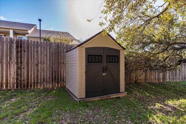 view of shed with a fenced backyard