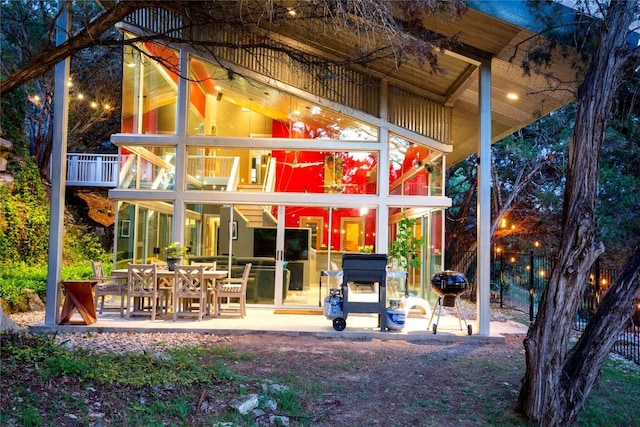 rear view of property with a balcony and a patio