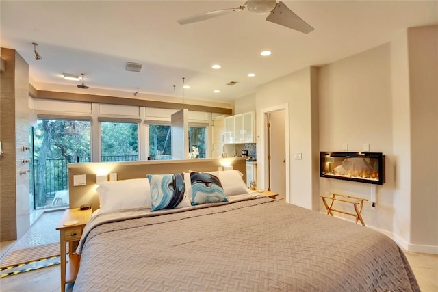 bedroom featuring recessed lighting, visible vents, baseboards, and a glass covered fireplace