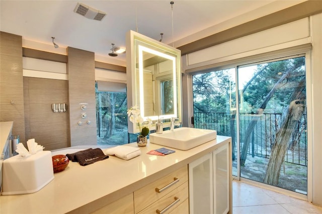 bathroom with vanity, visible vents, and tile patterned flooring