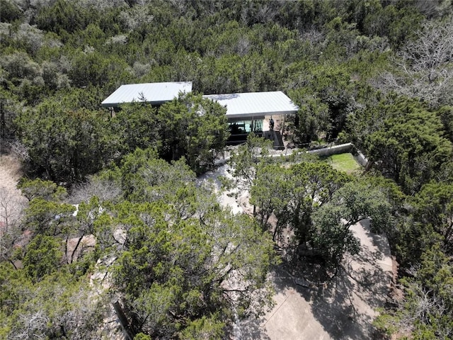 bird's eye view with a wooded view