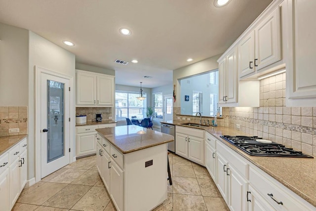 kitchen featuring visible vents, recessed lighting, a sink, stovetop with downdraft, and stainless steel dishwasher