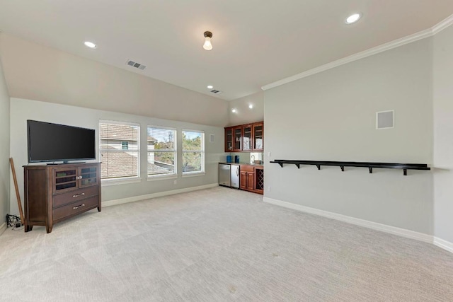 unfurnished living room with visible vents, baseboards, indoor bar, and light carpet