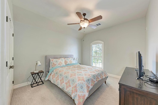 bedroom featuring visible vents, light colored carpet, a ceiling fan, and baseboards