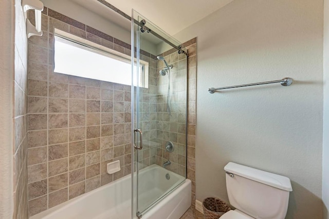 bathroom featuring toilet and enclosed tub / shower combo