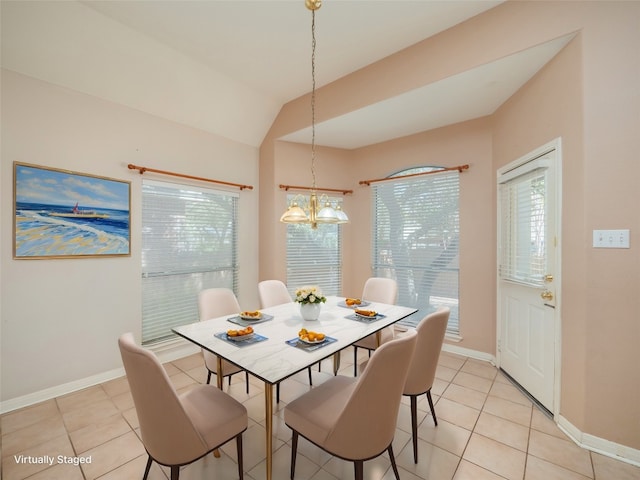 dining room with lofted ceiling, a notable chandelier, light tile patterned flooring, and baseboards