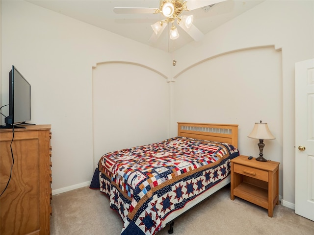 bedroom with baseboards, light colored carpet, and a ceiling fan