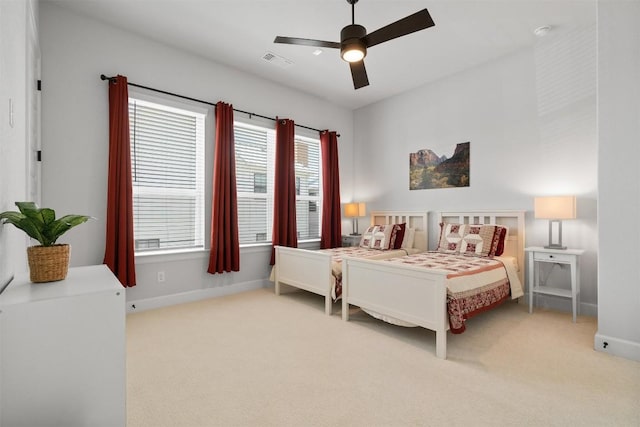 bedroom with ceiling fan, carpet, visible vents, and baseboards