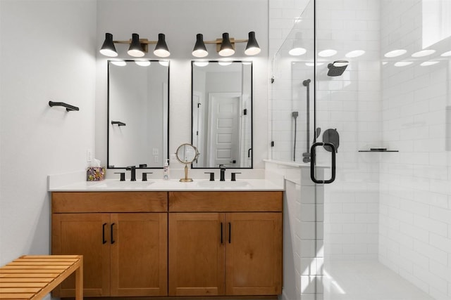 full bath featuring a shower stall, double vanity, and a sink