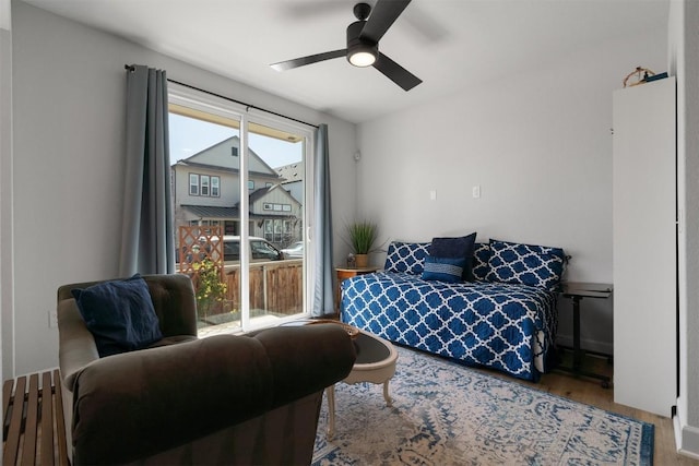 bedroom with access to outside, wood finished floors, and ceiling fan