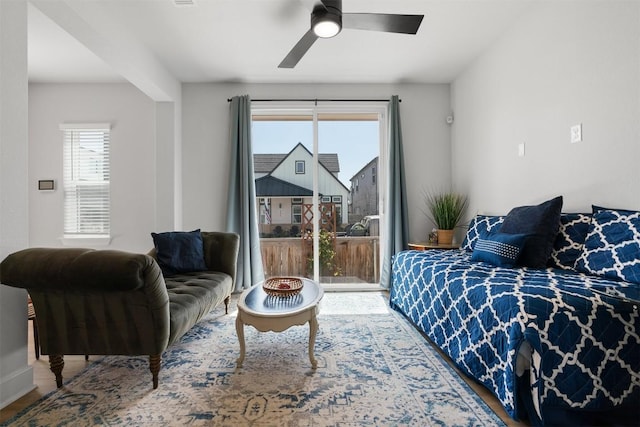 bedroom with wood finished floors, ceiling fan, and access to exterior